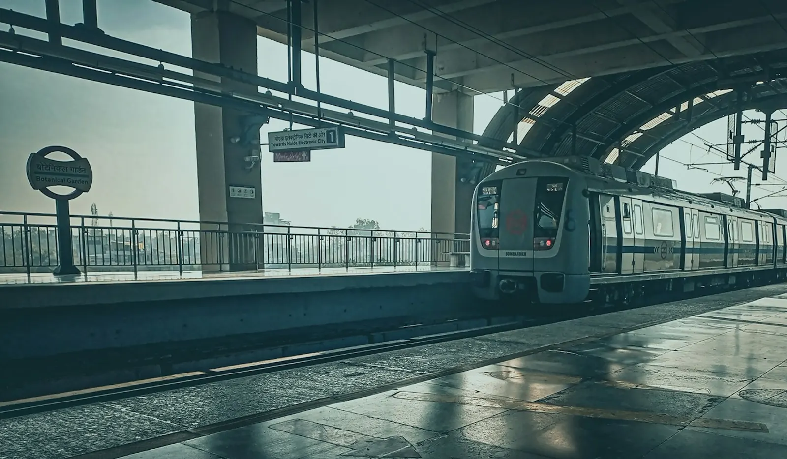 A Delhi Metro train at an elevated station